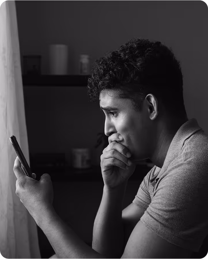 Man looking at phone after getting a colon cancer diagnosis